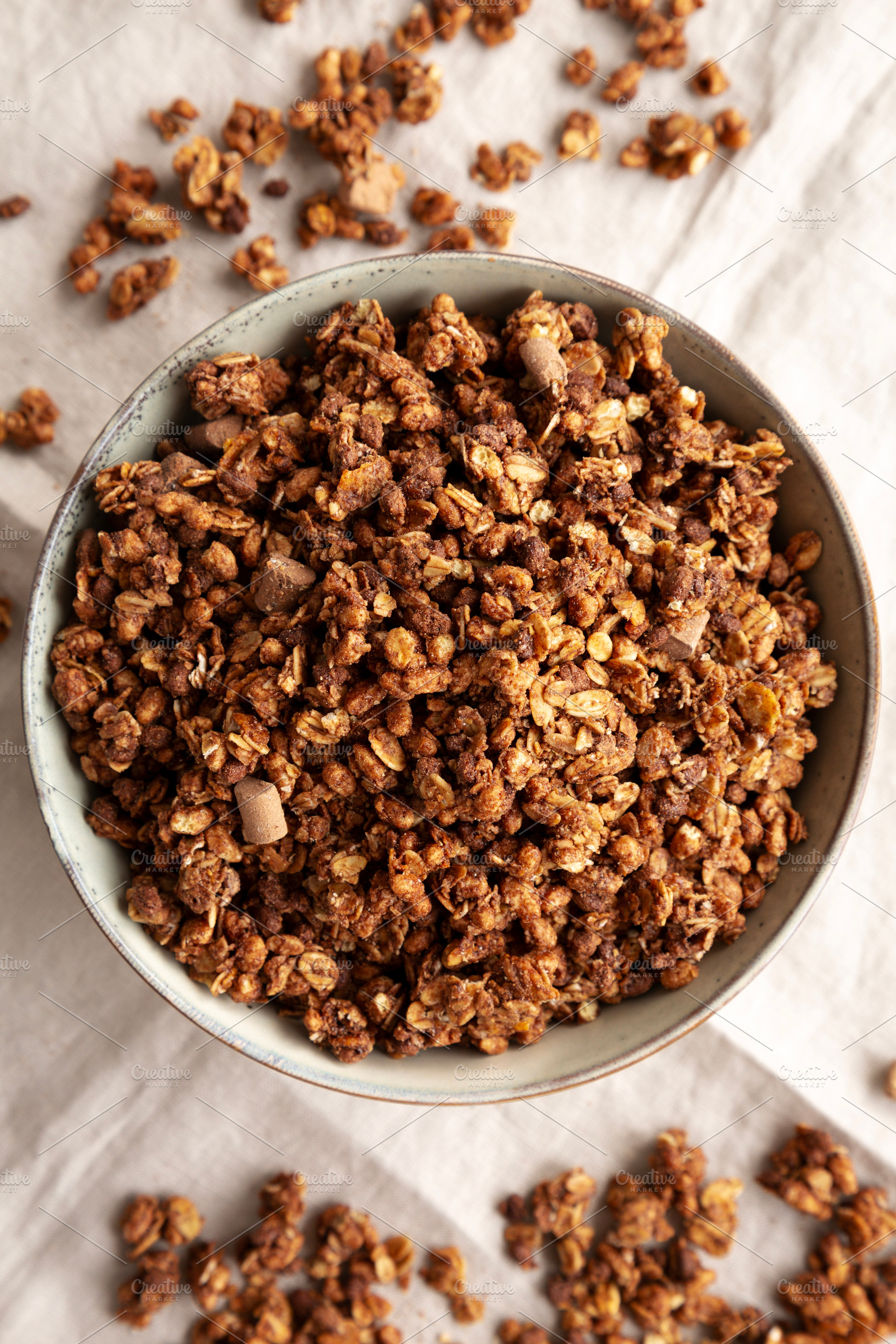 Homemade Healthy Chocolate Granola in a Bowl, top view., a Food & Drink Photo by LiudmylaChuhunova