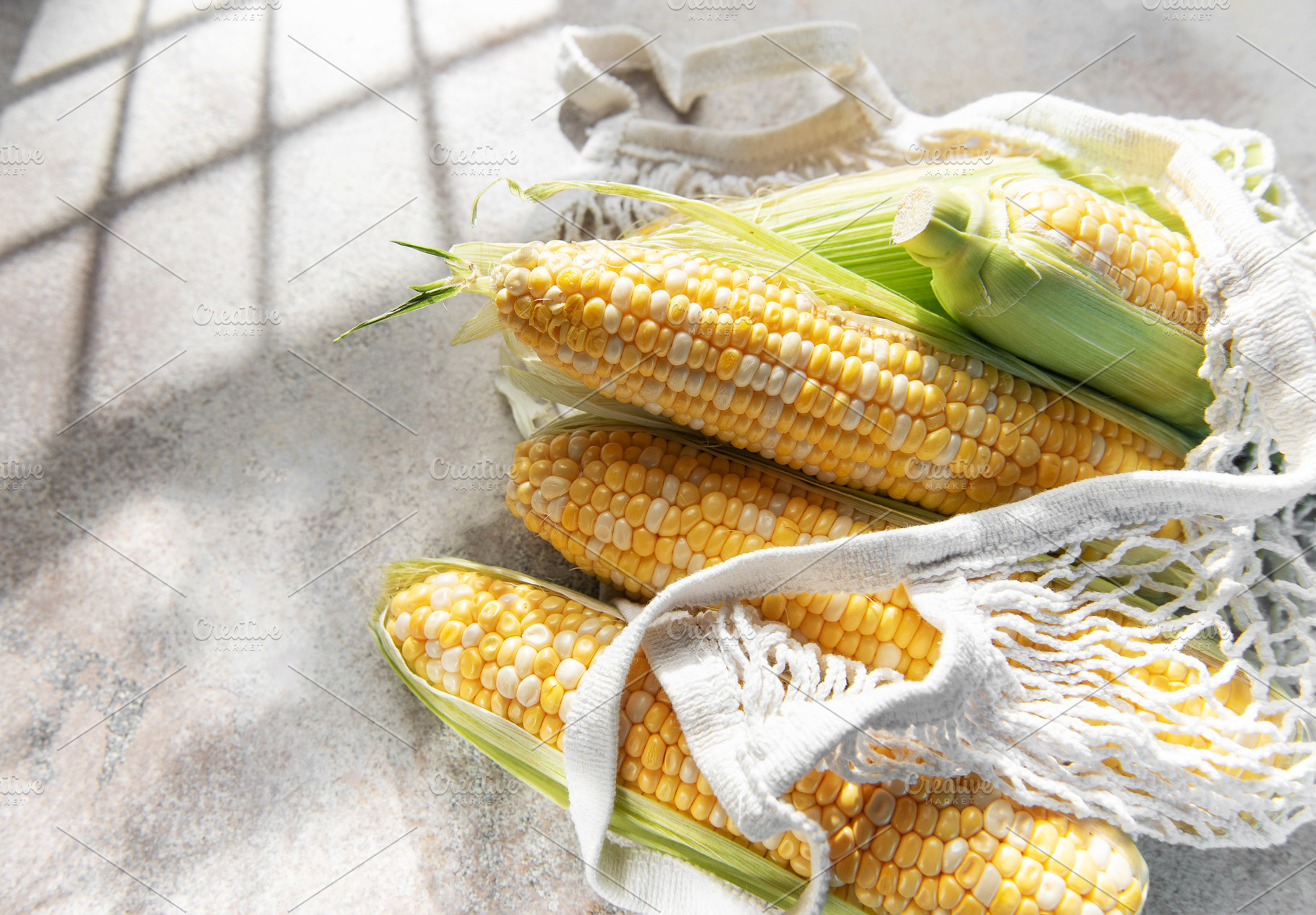 Fresh corn on the cob in eco friendly bag, a Food & Drink Photo by Olena Rudo