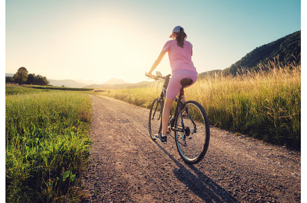 Woman is riding a mountain bike on, a Sports & Recreation Photo by den-belitsky