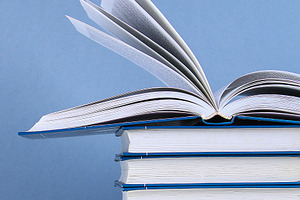 A stack of books on blue background.