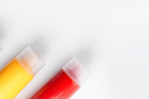 Three tubes of blue, yellow, and red paint arranged diagonally o, a Holiday Photo by Ales Munt