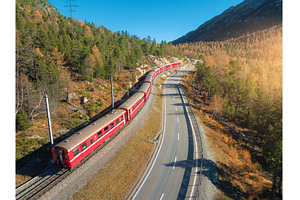 Aerial view of red train, river in, a Transportation Photo by den-belitsky