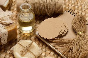 Handmade soap bars on marble stand and packaging items on table, a Food & Drink Photo by ndanko