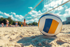 Volleyball on sandy beach with players in the background during a sunny day, a Photo by AlyaAnd