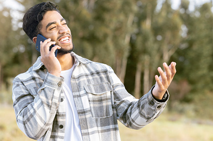 Happy, confused and phone call by man in a park, laughing while showing hand for wtf gesture on nature background. Smartphone, conversation and handsome male with hands, sign and surprised in forest, a Photo by Peopleimages.com