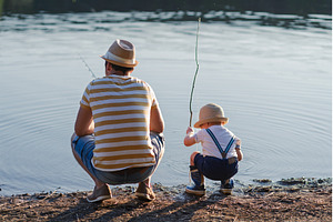 Dad teaching his little boy how to, a Person Photo by HalfPoint