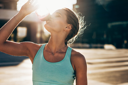 Woman drinking water after workout containing athlete, bottle, and break, a Sports & Recreation Photo by Jacob Lund