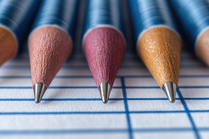 Colorful pencils arranged in a row o, a Photo by Tanuart