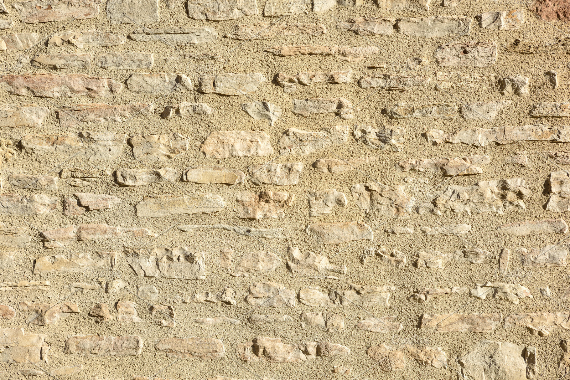 Wall of gray stones held together with brown cement, a Background Photo by Davizro's Market
