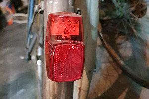 bike parked in garage, focus on light, a Photo by WorldOfPhotos