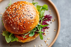 Delicious cheeseburger with fresh toppings, a Food & Drink Photo by AlyaAnd