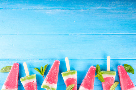Tasty sweet watermelon ice cream lollies on blue wooden table, a Food & Drink Photo by Rimma