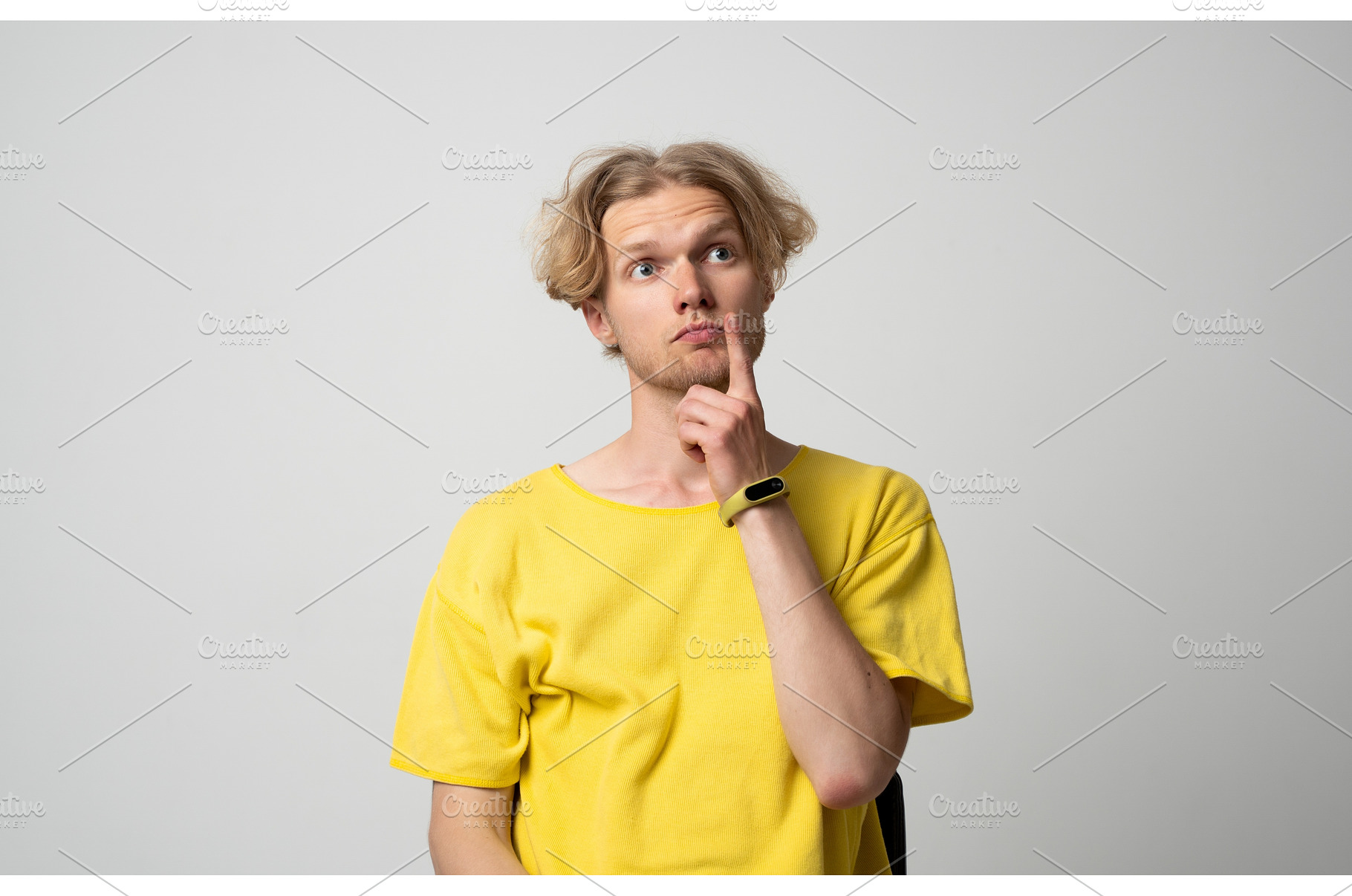Thoughtful young man in yellow t, a Person Photo by volodymyrshtun13795
