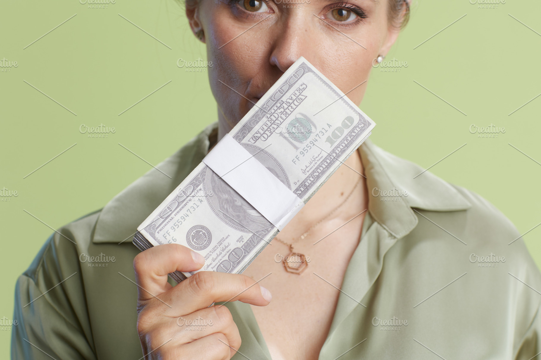 Hidden wealth, money in front of face, a Business Photo by Alliance Images