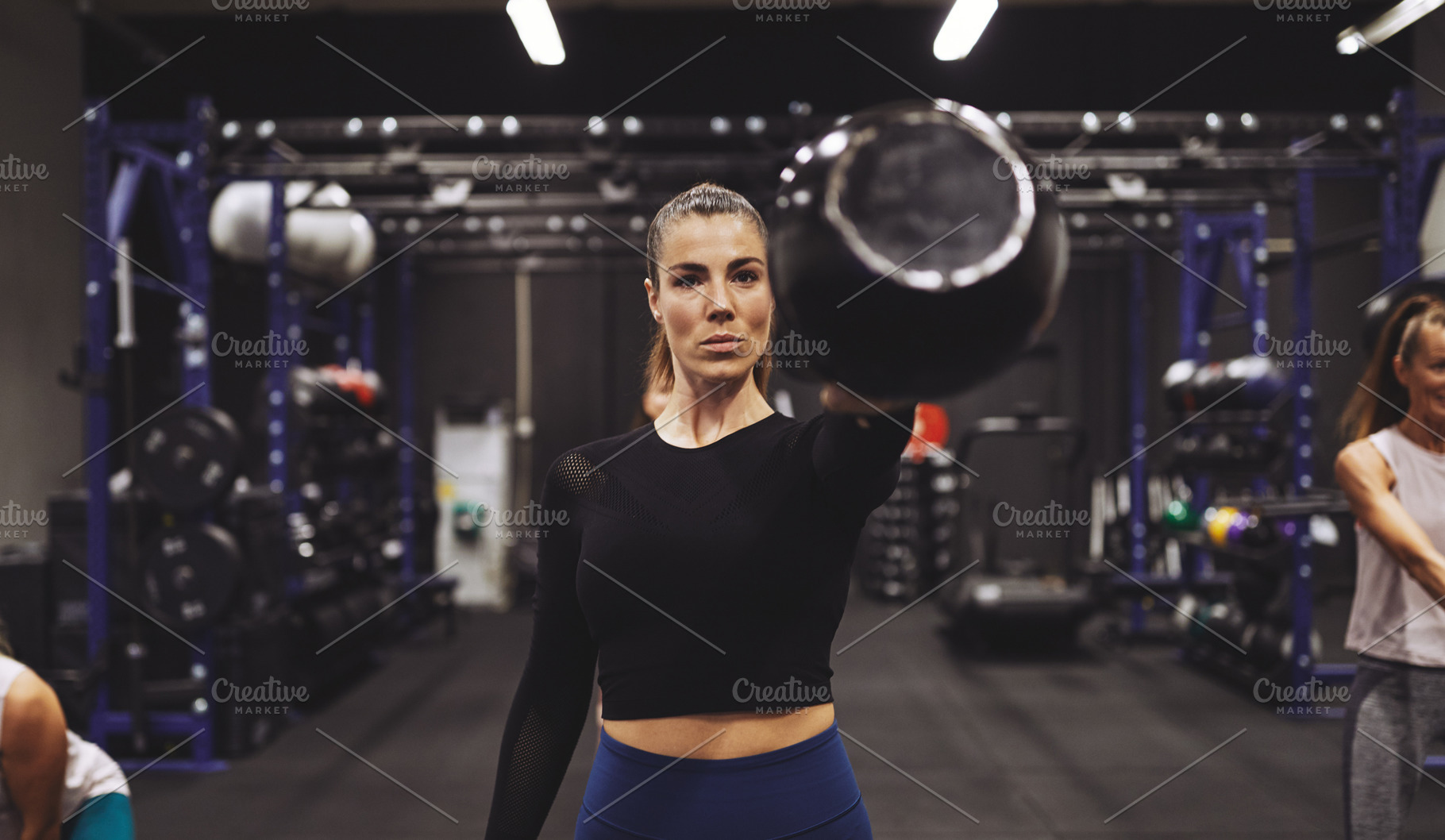 Young woman exercising with a dumbbell at the gym, a Sports & Recreation Photo by Stefan & Janni