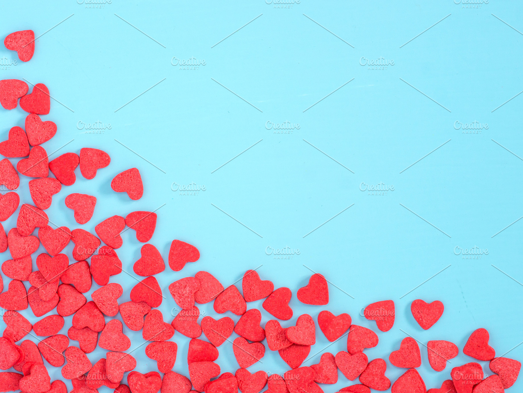Border frame of red hearthshape sprinkle on blue background stock photo, a Holiday Photo by Fascinadora