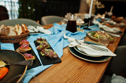 Beautifully laid tables with food, glasses and appliances in res, a Food & Drink Photo by AS photostudio