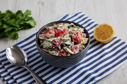 Homemade Tomato Cucumber Feta Salad in a Bowl, side view., a Food & Drink Photo by LiudmylaChuhunova