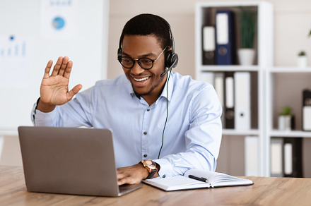 Cheerful black guy greeting business partners, having online conference, a Photo by Prostock-Studio