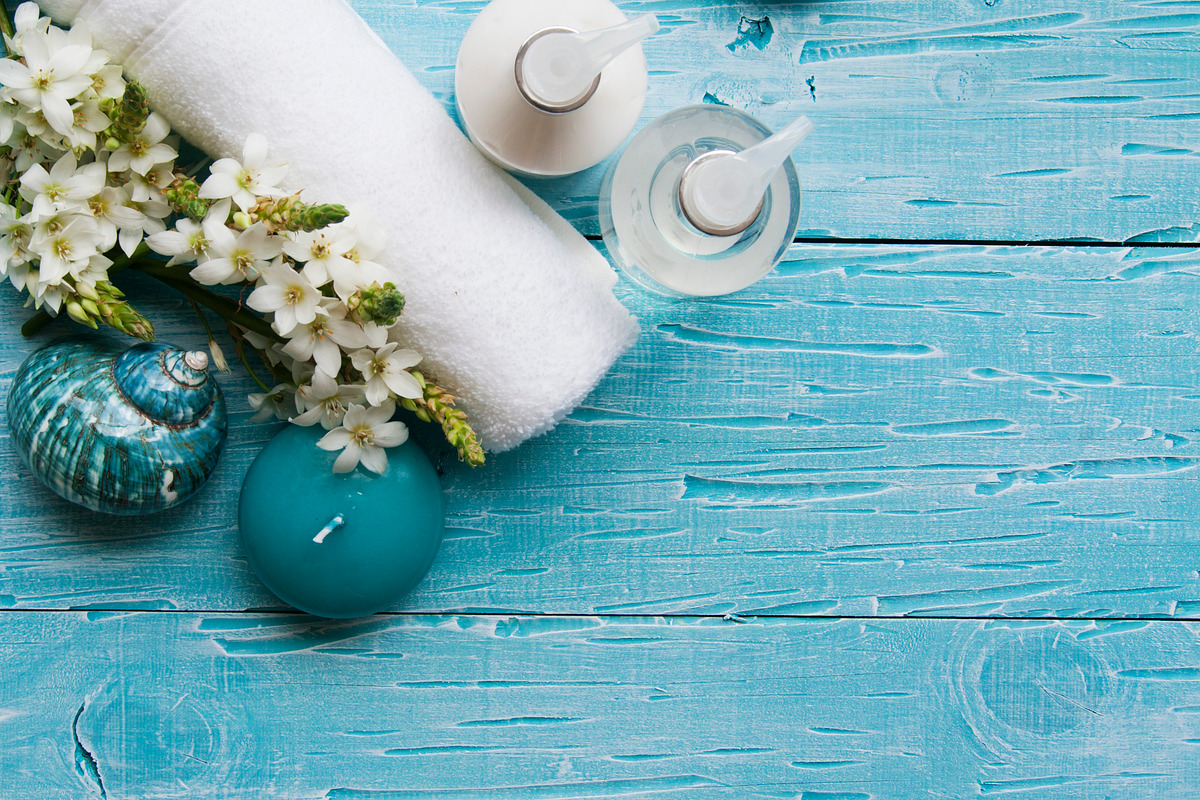 White flowers lying on and candle spa set containing towel, soap, and spa, a Health & Medical Photo by Wild Drago Shop (Photo 1 of 2)