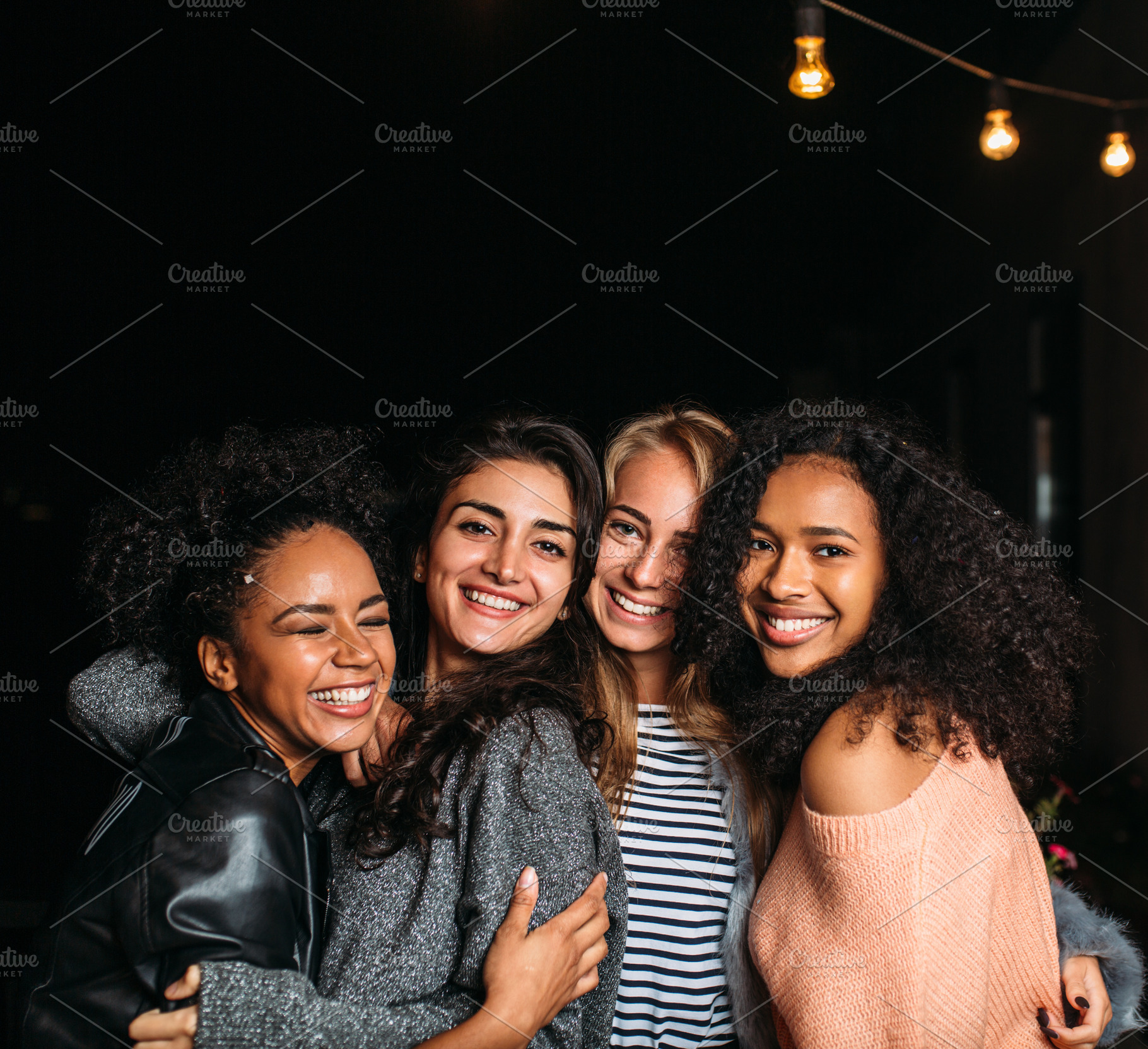 Group of four laughing females, a Person Photo by Artem Varnitsin
