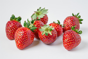 Red strawberries isolated on white background, a Food & Drink Photo by AlyaAnd