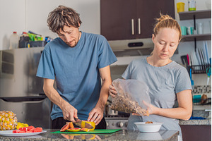 Woman and man preparing breakfast, a Person Photo by Elizaveta Galitskaya