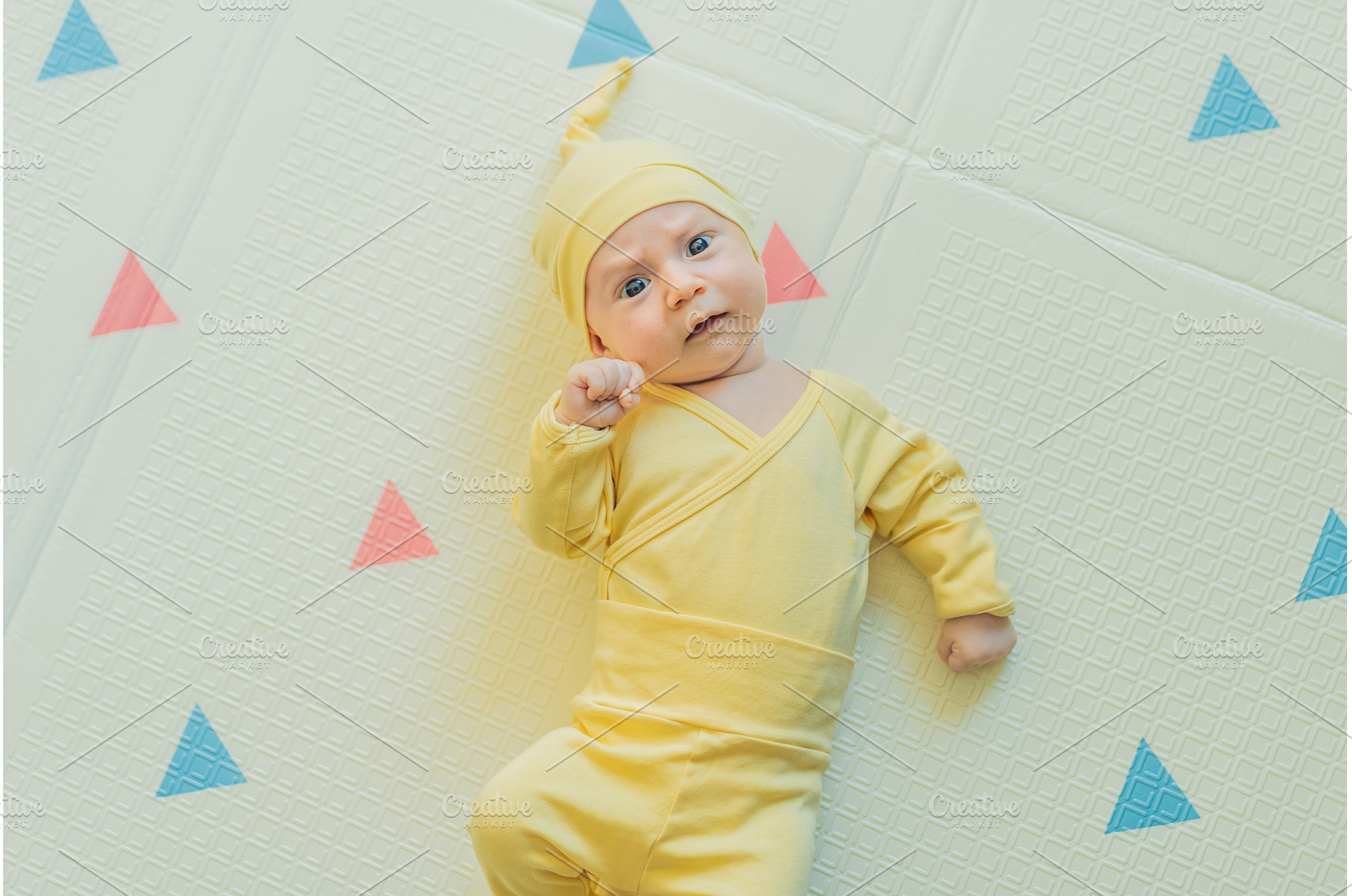 Adorable baby in a yellow hat lying, a Person Photo by Elizaveta Galitskaya
