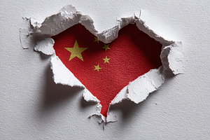 Chinese flag heart shape torn paper, a Photo by Pixeness Studio