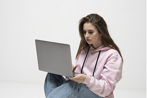 Young woman sitting on floor in pink, a Person Photo by volodymyrshtun13795