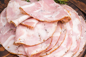 Slices of authentic Italian Pancetta Arrotolata served on a dark, a Food & Drink Photo by composter-box@mail.ru