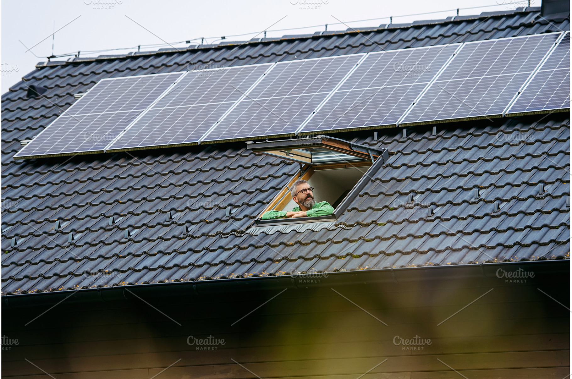 Man looking from skylight, roof, a Technology Photo by HalfPoint