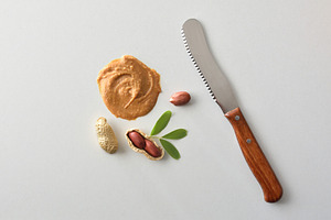 Conceptual background of peanut butter with product knife and fr, a Food & Drink Photo by Davizro's Market