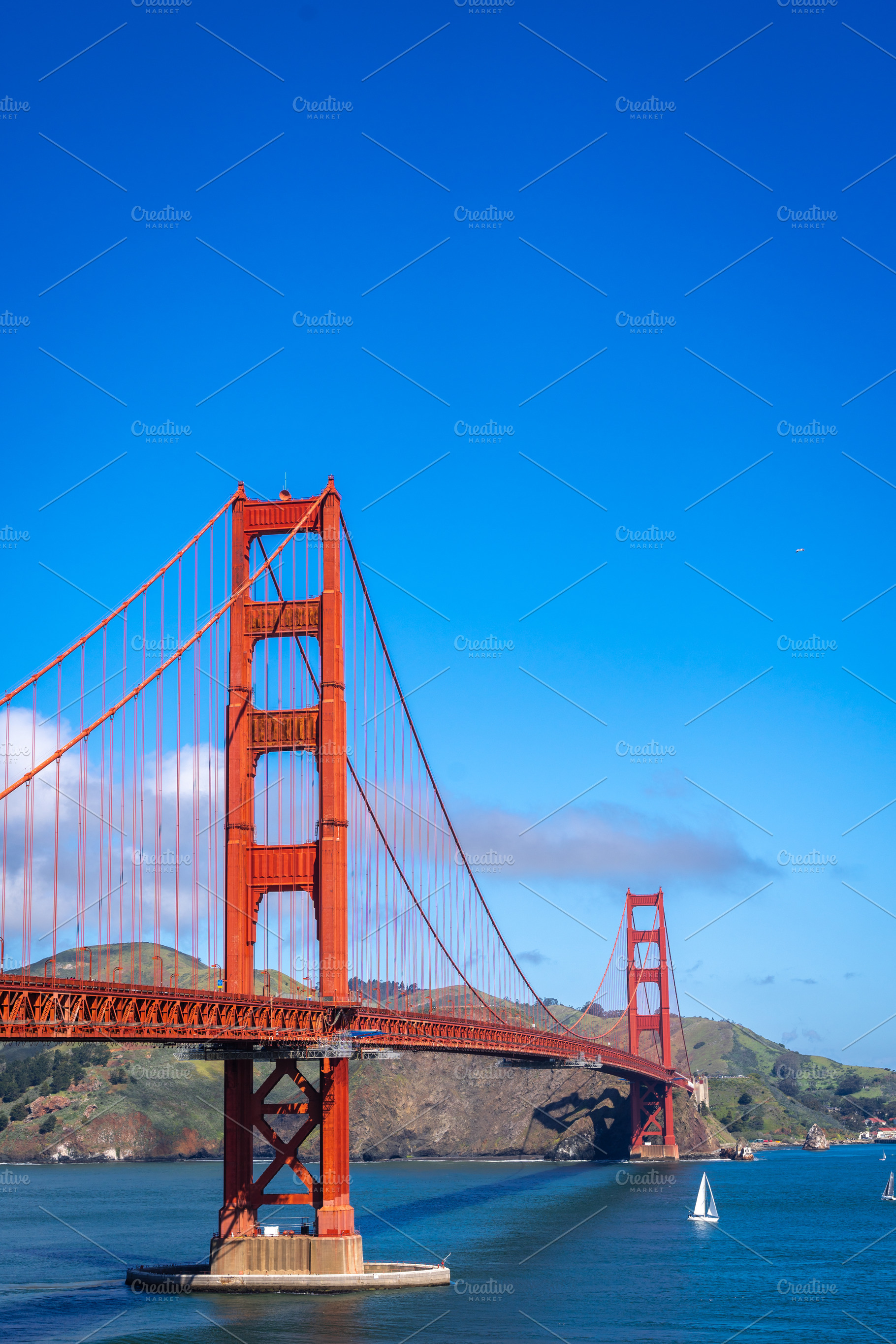 Golden Gate Bridge over blue waters with scenic hills in San Fra, an Architecture Photo by GoodGoods