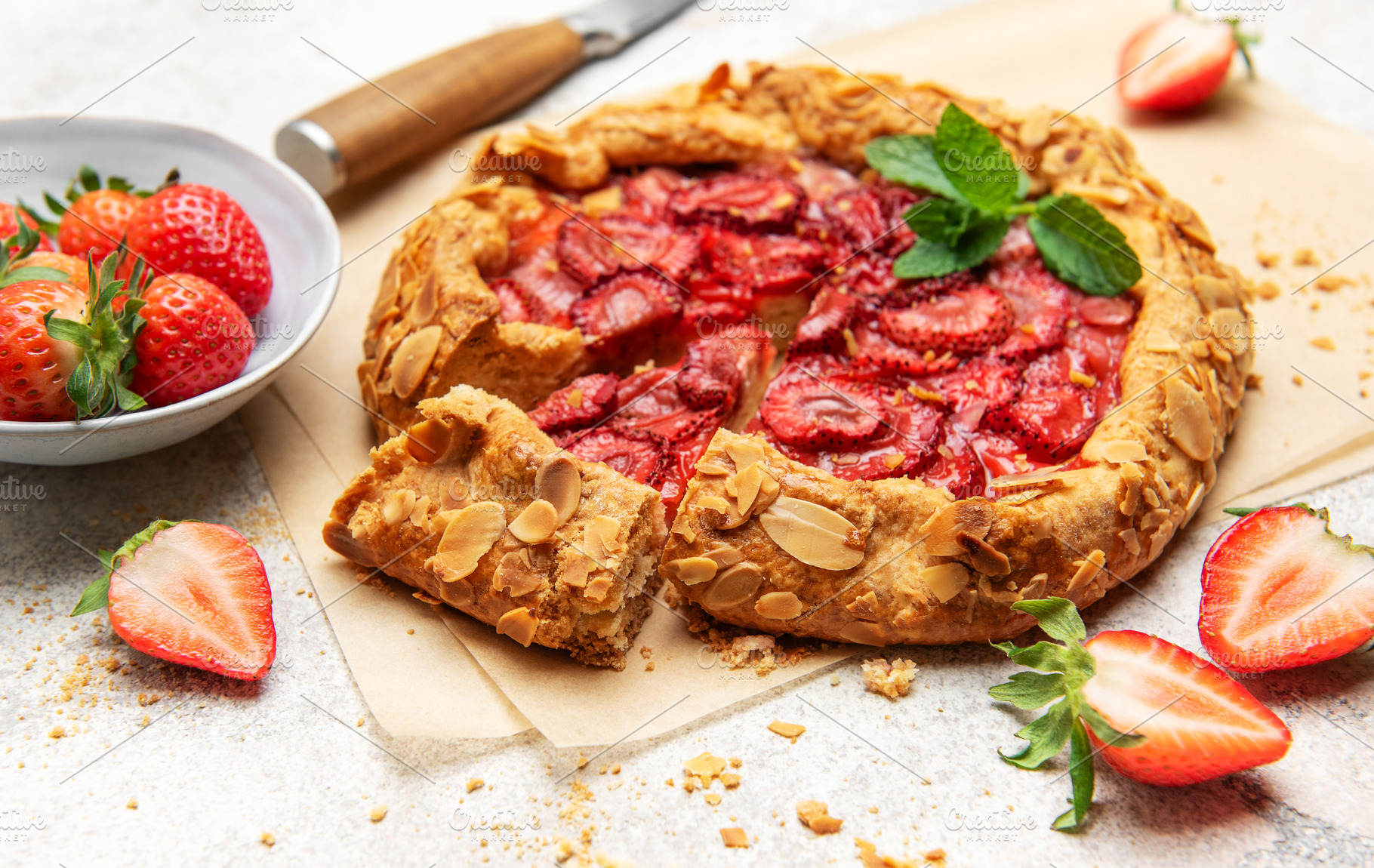 Delicious homemade strawberry galette with almond flakes and fre, a Food & Drink Photo by Olena Rudo
