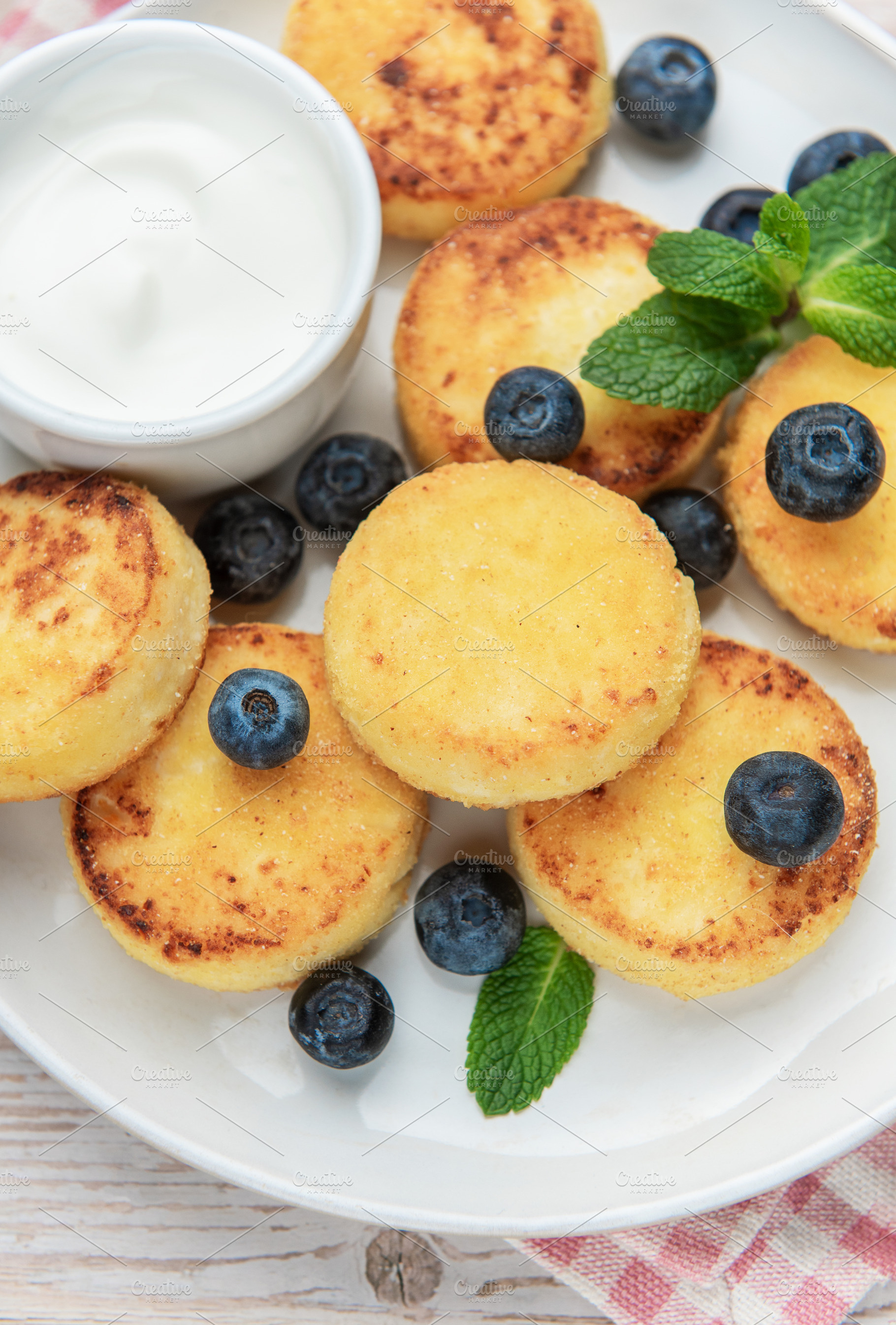 Cottage cheese pancakes with blueberries and sour cream, a Food & Drink Photo by Olena Rudo