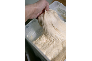 Hand Stretching Dough In Container, a Food & Drink Photo by Natasha Breen