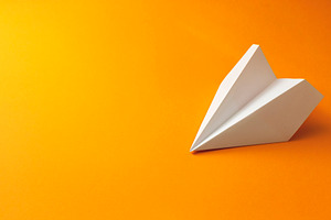 Paper plane on an orange background