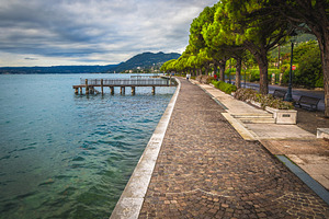 Stunning walkway and Lake Garda, a Nature Photo by Alpine Dreams