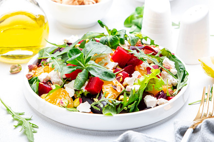 Beetroot and white cheese salad with arugula, lettuce,  orange a, a Food & Drink Photo by 5PH