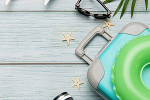 Travel accessories lying on wooden background for summer vacatio, a Holiday Photo by Olena Rudo