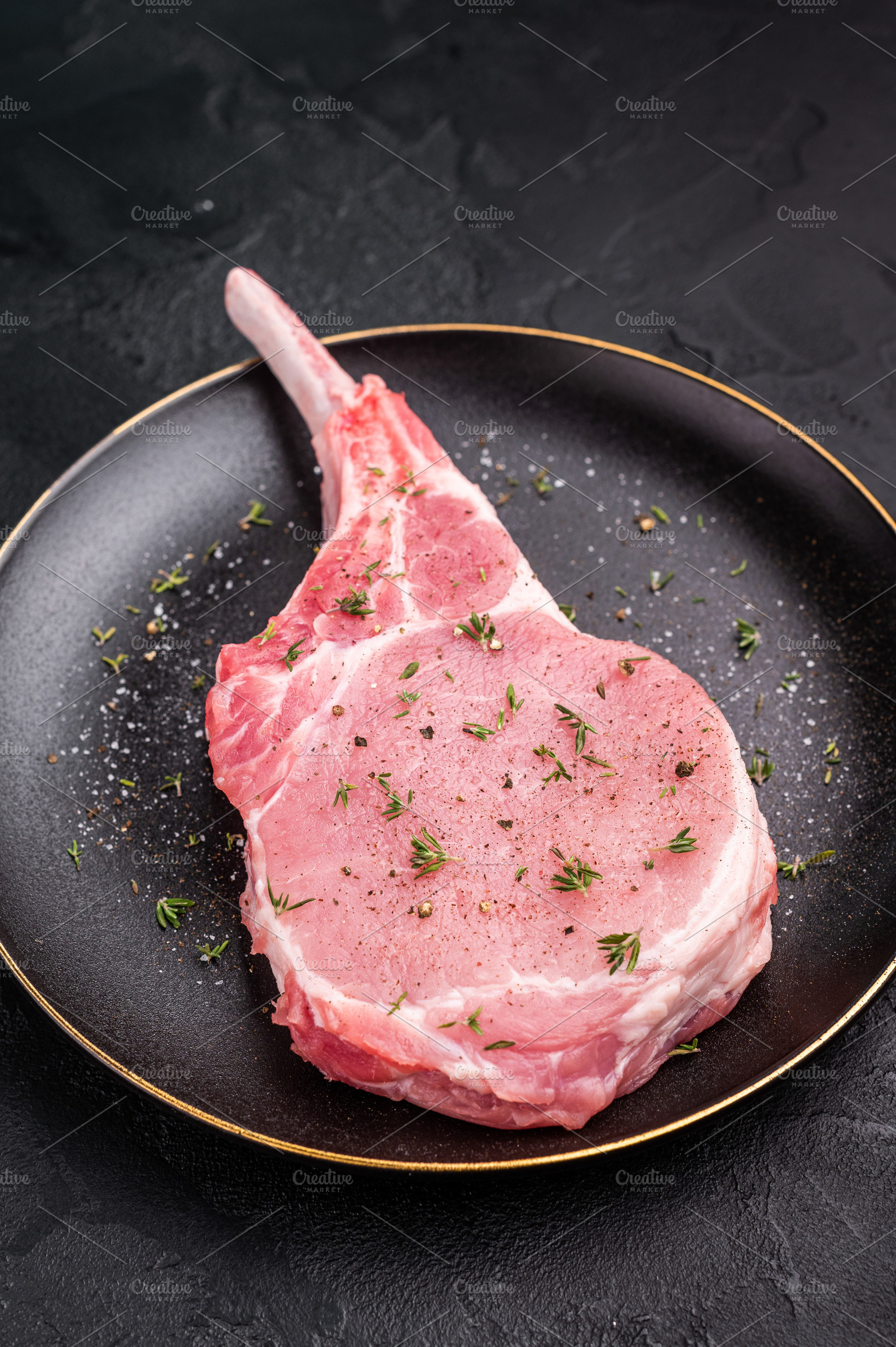 Juicy raw pork chop with bone in, waiting to be transformed into, a Food & Drink Photo by composter-box@mail.ru