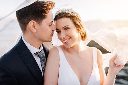 Portrait of a just married couple under the bride's veil, a Person Photo by rubenchase