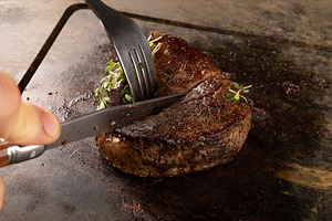 Chef cutting grilled steak, a Photo by Grafvision photography