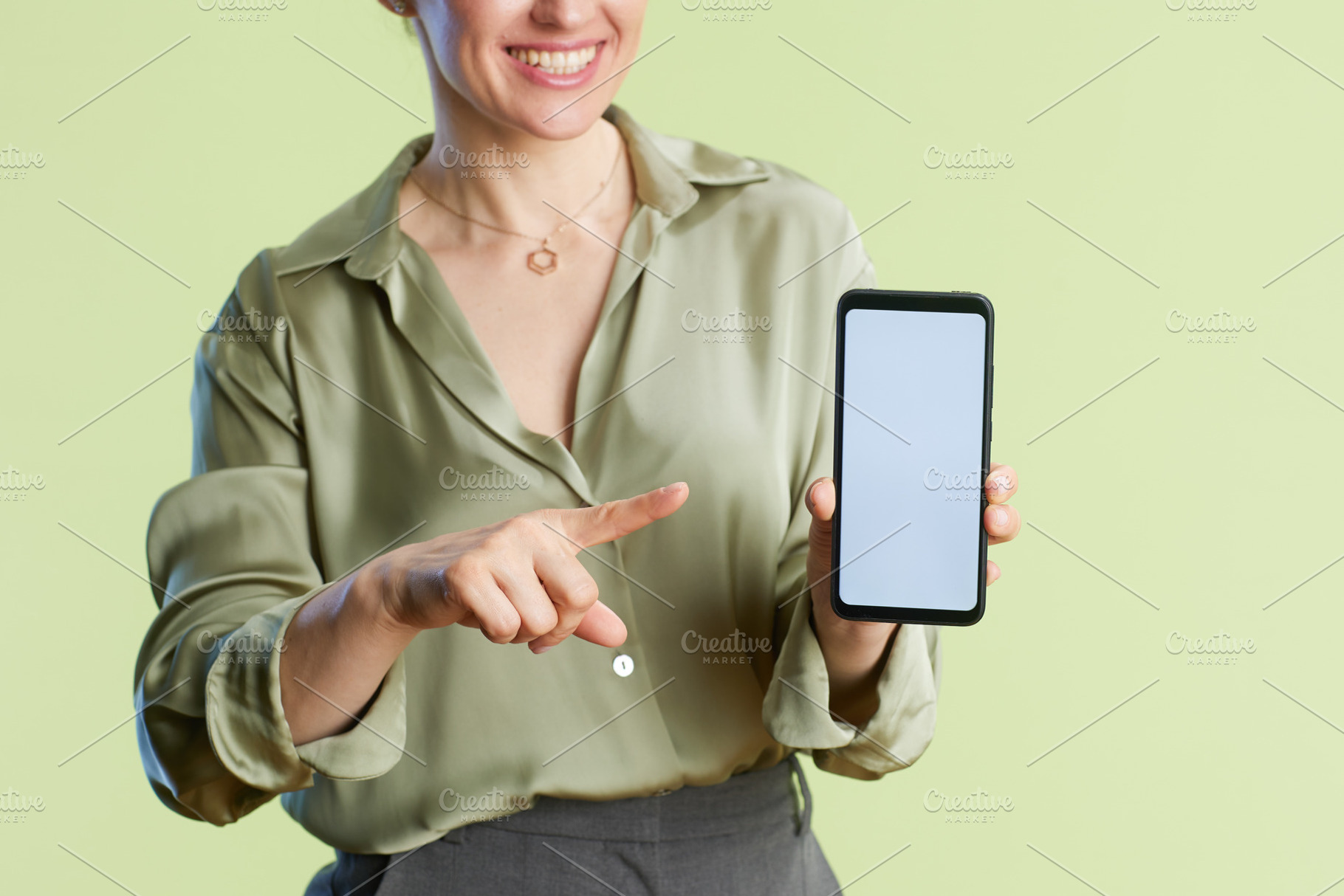 Woman Points to Smartphone Screen, a Person Photo by Alliance Images