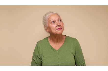 An elderly European woman looks with