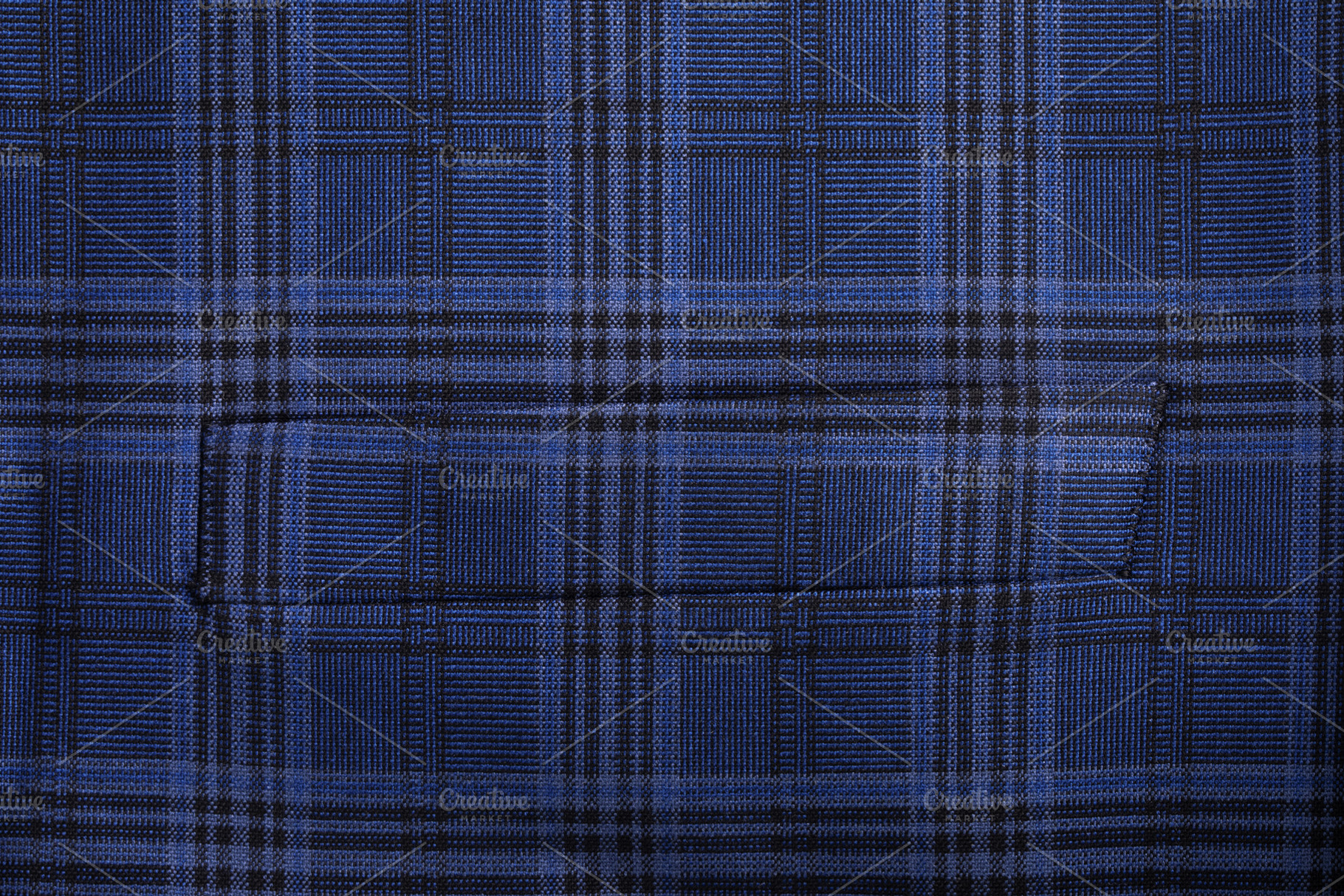 Close-up of blue plaid patterned fabric with pocket seam, ideal, a Food & Drink Photo by Ales Munt