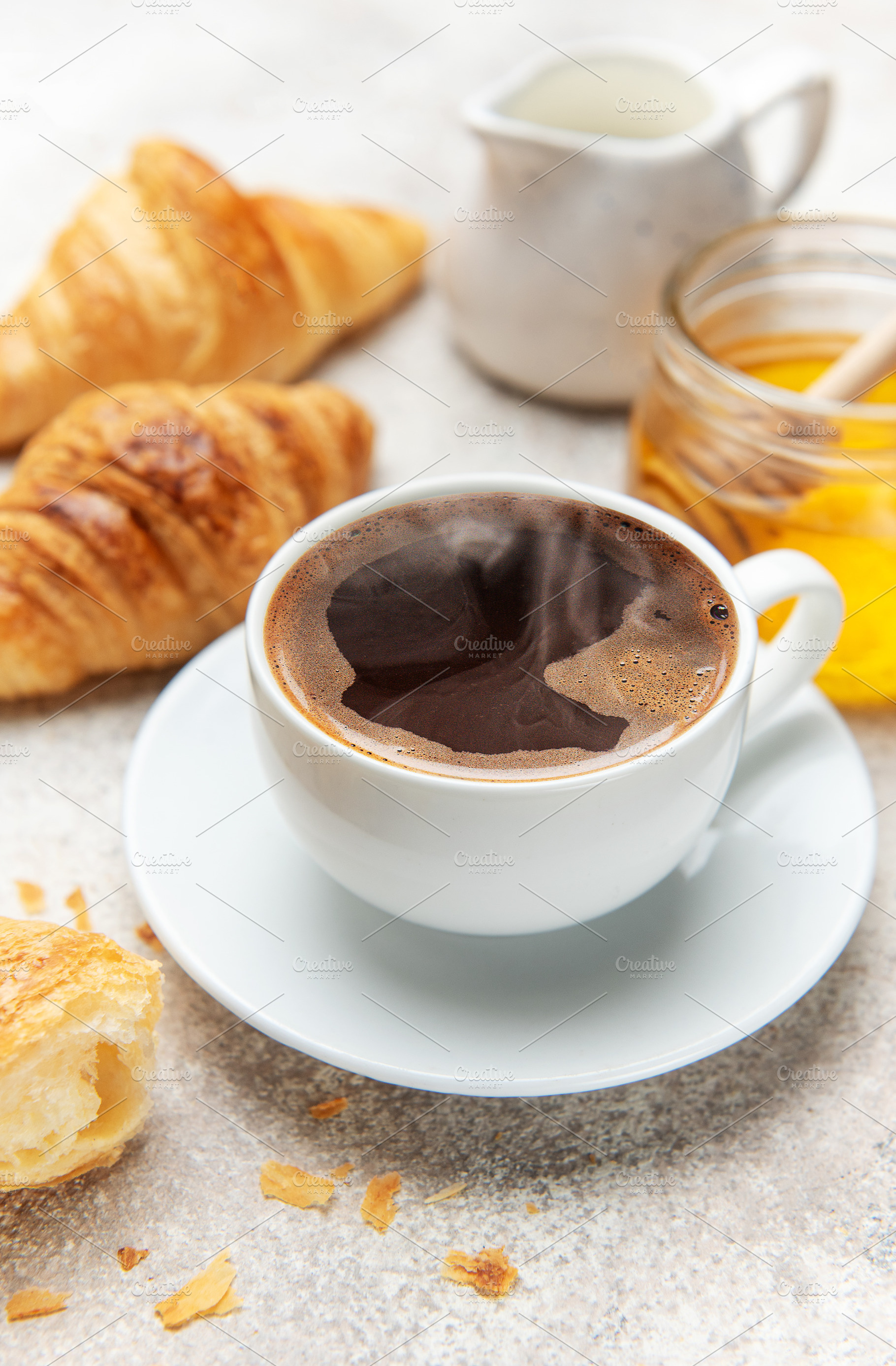 Steaming coffee, fresh croissants, and honey create a tempting b, a Food & Drink Photo by Olena Rudo