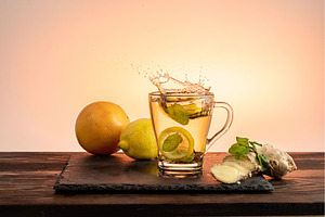 Glass cup with lemon, mint, and, a Food & Drink Photo by Stockphoto by vzwer