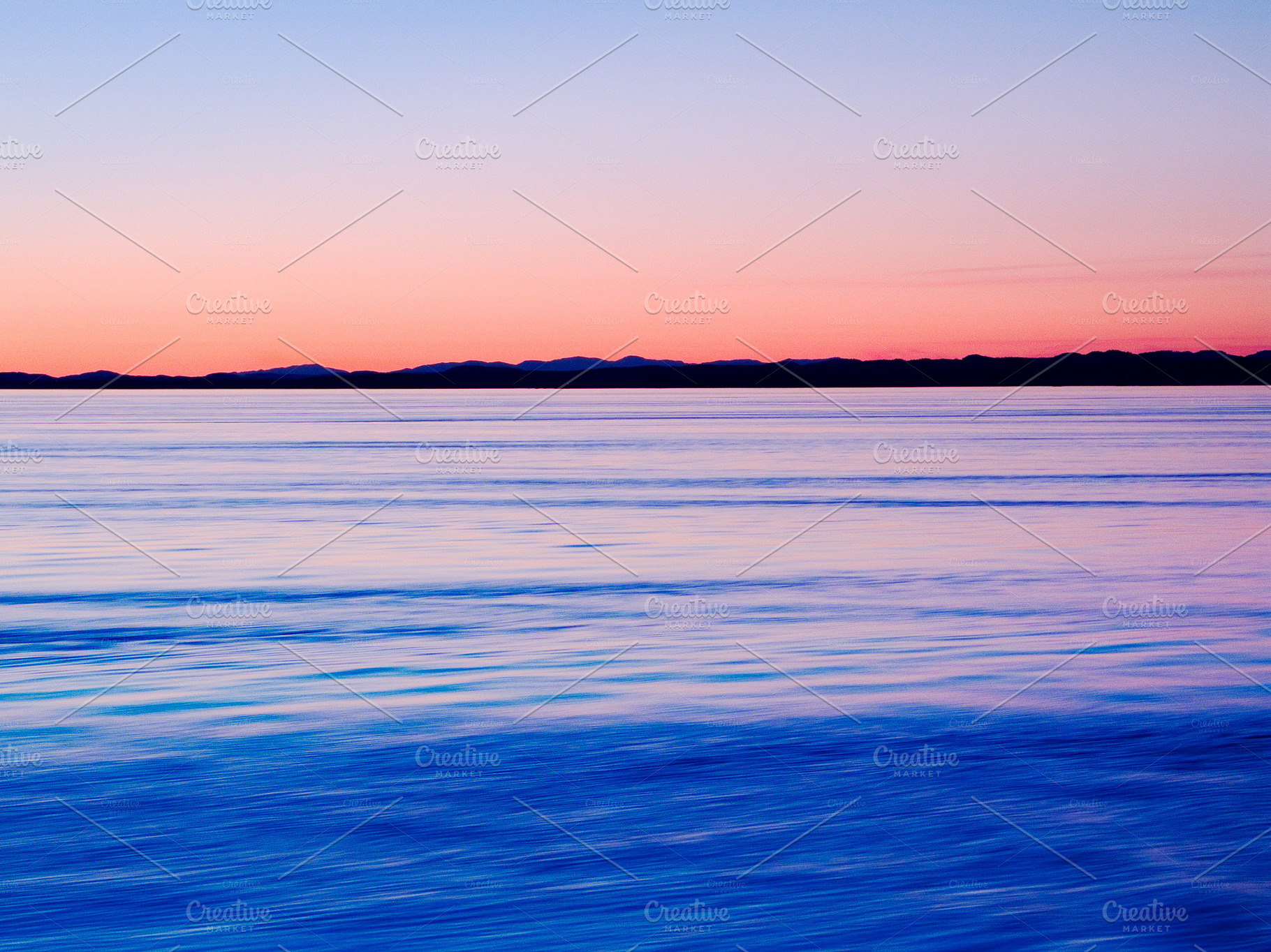 A calm lake and a gorgeous sunset, a Photo by Peopleimages.com